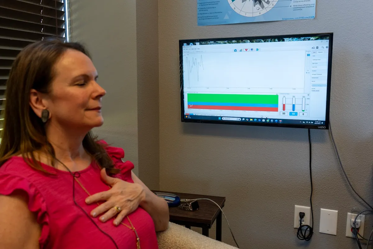 A HeartMath session — hand on heart, heart-rate coherence on the screen