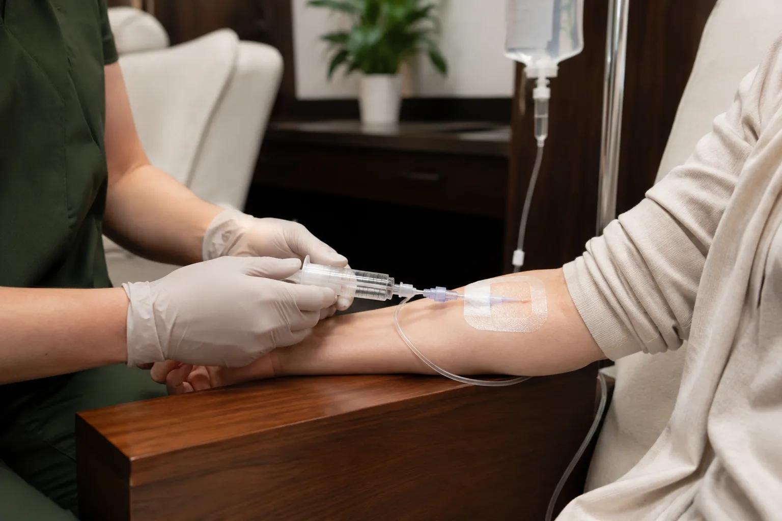 A syringe administered into an IV line at a client's arm