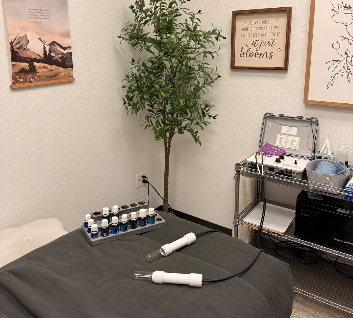 The lymphatic room &mdash; the LymphStar&reg; Pro on its cart, its two glass wands on the table, and the Raindrop oils on their tray