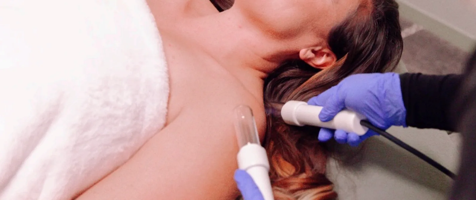 A lymphatic drainage session &mdash; two wands worked along the neck and collarbone