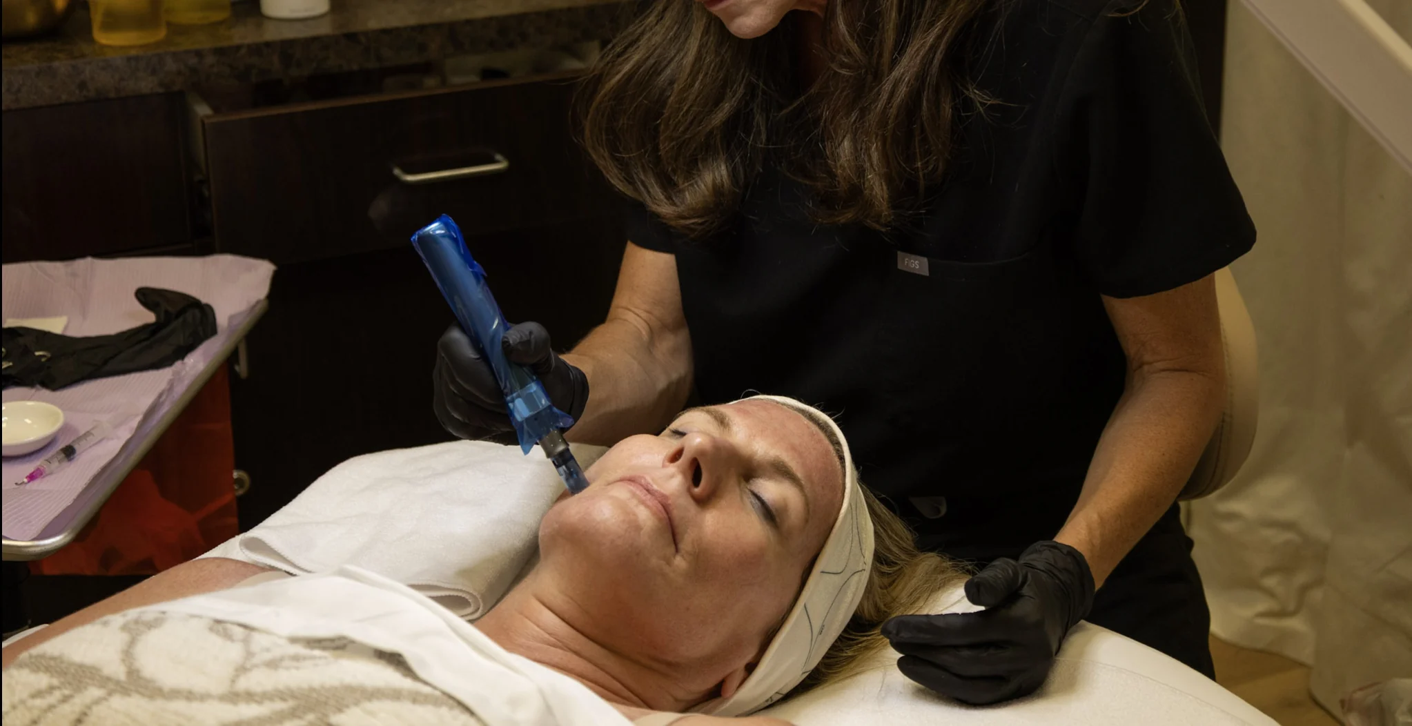 Rachel performing a microneedling treatment on a client's cheek