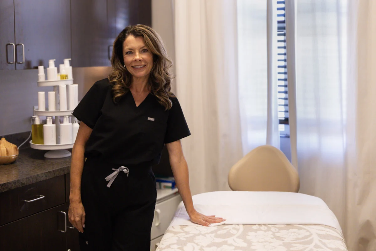 Rachel Allenbrand in the aesthetics treatment room, her Green Envee display on the counter beside her