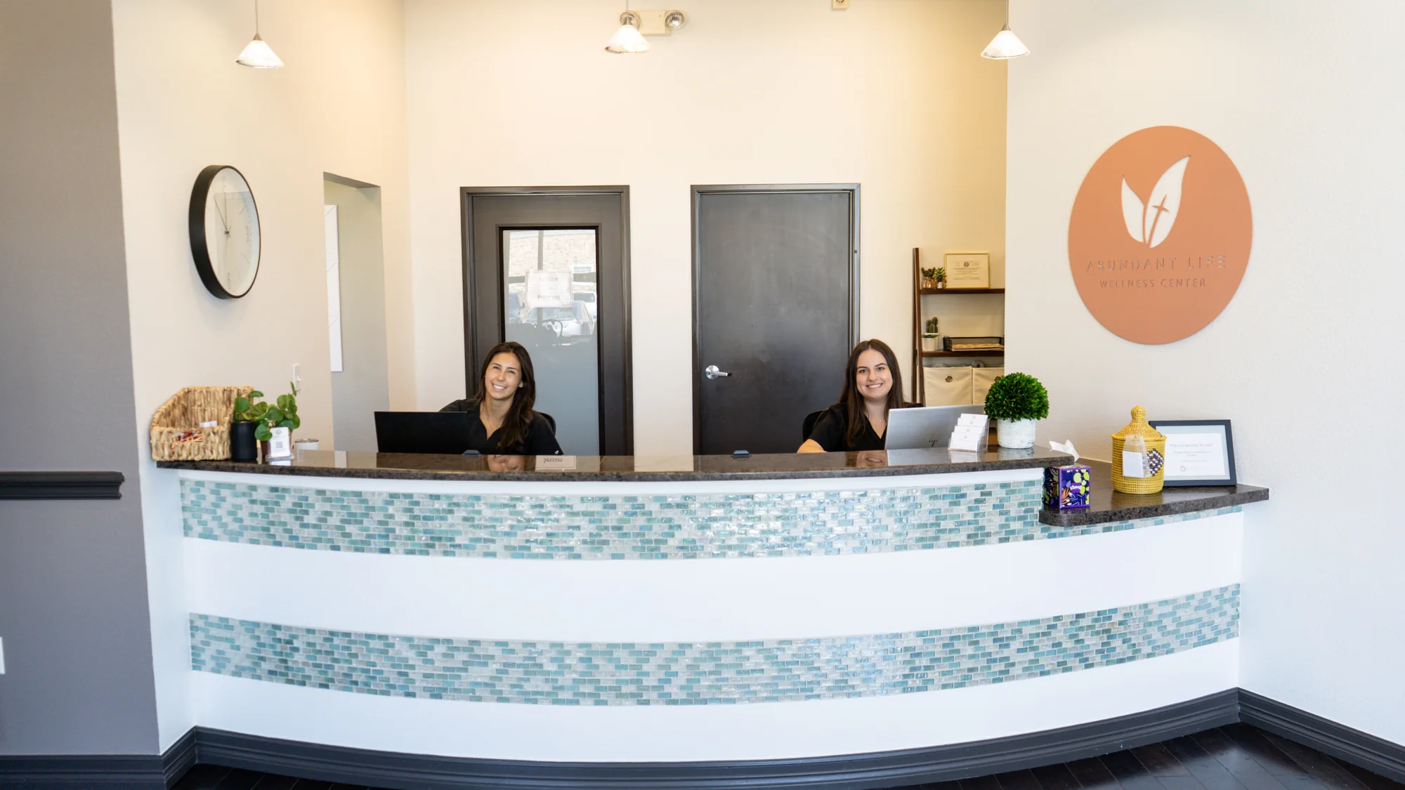 A practitioner walking a client through paperwork at the consultation desk