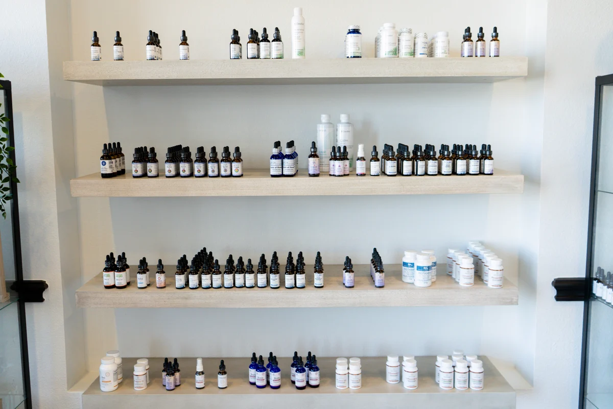 Open shelves stocked with supplement bottles at the practice