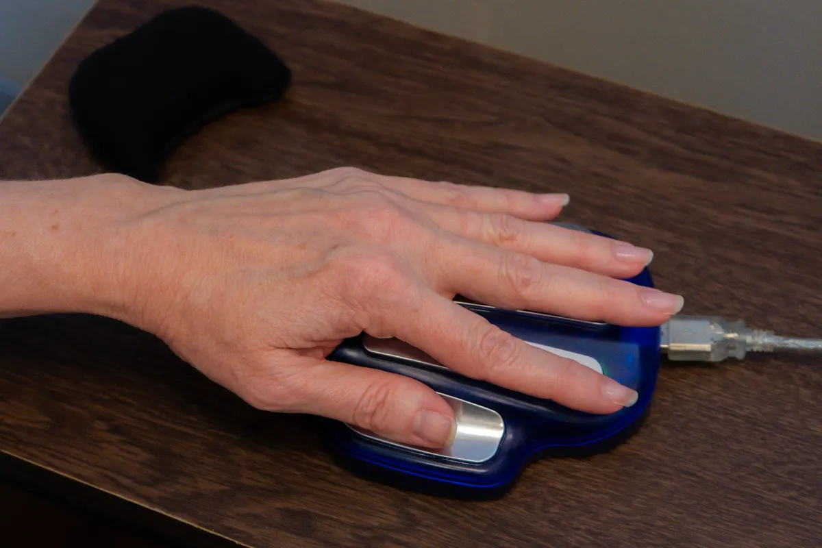 A hand resting on the ZYTO cradle